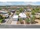 Expansive aerial view of modern home with a pool, garage, and mountain views, perfect for serene living at 3043 E Hartford Ave, Phoenix, AZ 85032