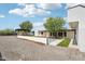 Backyard with modern home, swimming pool, pergola, and mature trees at 3043 E Hartford Ave, Phoenix, AZ 85032
