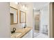 Bright bathroom with double sink vanity, granite counters, and tiled walk-in shower at 3043 E Hartford Ave, Phoenix, AZ 85032