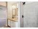 Modern bathroom with dual sink vanity, granite countertop, and glass-enclosed shower at 3043 E Hartford Ave, Phoenix, AZ 85032