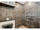 Modern bathroom with decorative tiled shower with built-in niche and sleek fixtures at 3043 E Hartford Ave, Phoenix, AZ 85032