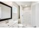 Bathroom with white cabinetry, a large mirror, updated fixtures, and a walk-in shower at 3043 E Hartford Ave, Phoenix, AZ 85032