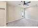 Spacious bedroom featuring large ceiling fan, backyard access, and carpet floors at 3043 E Hartford Ave, Phoenix, AZ 85032
