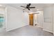 Well-lit room with ceiling fan, carpet floor, and rustic barn door to bathroom at 3043 E Hartford Ave, Phoenix, AZ 85032