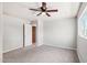 Spacious bedroom featuring plush carpet, a ceiling fan, and a neutral color scheme at 3043 E Hartford Ave, Phoenix, AZ 85032