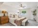 Bedroom with a large bed with lots of pillows, light colored walls and ceiling fan at 3043 E Hartford Ave, Phoenix, AZ 85032