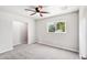Bedroom with carpet, ceiling fan, a window overlooking mature landscaping, and neutral walls at 3043 E Hartford Ave, Phoenix, AZ 85032