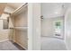 Spacious bedroom featuring large closet with shelves, carpet flooring, and access to backyard at 3043 E Hartford Ave, Phoenix, AZ 85032