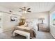 Bedroom featuring a ceiling fan, dresser, a plush bed, and a window at 3043 E Hartford Ave, Phoenix, AZ 85032