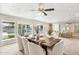Elegant dining room with large windows overlooking the backyard pool and manicured lawn at 3043 E Hartford Ave, Phoenix, AZ 85032