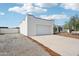 View of the home featuring the white garage, concrete driveway, and gravel landscaping at 3043 E Hartford Ave, Phoenix, AZ 85032