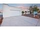 Contemporary home showcasing a clean garage facade, long driveway, and fresh landscaping at 3043 E Hartford Ave, Phoenix, AZ 85032