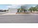 Charming single-story home showcasing a white garage and stucco exterior with a well-manicured front yard at 3043 E Hartford Ave, Phoenix, AZ 85032