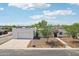 Aerial shot showcasing the home's front exterior, garage, desert landscaping, and well-maintained lawn at 3043 E Hartford Ave, Phoenix, AZ 85032