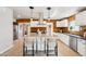 Kitchen features an island with seating, stainless steel appliances, and farmhouse backsplash at 3043 E Hartford Ave, Phoenix, AZ 85032