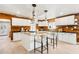 Modern kitchen features a large island, updated appliances, and stylish wooden accent wall at 3043 E Hartford Ave, Phoenix, AZ 85032