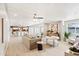 Expansive living room with tile floors, modern furnishings, and an open layout leading to the kitchen and dining area at 3043 E Hartford Ave, Phoenix, AZ 85032
