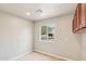Empty mud room with overhead cabinets, a window with a view and lots of light at 3043 E Hartford Ave, Phoenix, AZ 85032