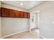 Empty mud room with overhead cabinets and a white door at 3043 E Hartford Ave, Phoenix, AZ 85032