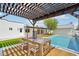 Outdoor patio with pergola, dining table, and views of the refreshing pool and yard at 3043 E Hartford Ave, Phoenix, AZ 85032
