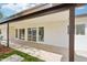 Covered patio showcasing wood beams, tile flooring, and multiple sliding glass doors leading to the backyard at 3043 E Hartford Ave, Phoenix, AZ 85032