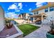 A lush backyard featuring a dining area, lounge area, pergola, and green lawn at 306 W Culver St, Phoenix, AZ 85003