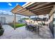 This backyard features a dining area, lounge area, pergola, and a green grass area at 306 W Culver St, Phoenix, AZ 85003