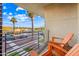 Relaxing balcony with chairs offering a scenic view of palm trees, street, and blue sky at 306 W Culver St, Phoenix, AZ 85003