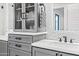 Close-up of a vanity in a bathroom featuring white marble counters and shaker cabinets at 306 W Culver St, Phoenix, AZ 85003