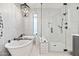 Bright bathroom features a freestanding tub, a glass shower, and tiled walls at 306 W Culver St, Phoenix, AZ 85003