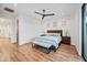 Bright bedroom featuring a king bed, wood floors, and many windows at 306 W Culver St, Phoenix, AZ 85003