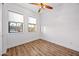 A bright bedroom featuring vinyl floors, white walls, and natural light from two windows at 306 W Culver St, Phoenix, AZ 85003