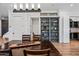 Dining room with wood table and floors, custom shelving, and a view of the entry at 306 W Culver St, Phoenix, AZ 85003