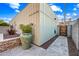 Landscaped side yard featuring stone pavers, a large planter, and an exterior wood door at 306 W Culver St, Phoenix, AZ 85003