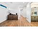 Spacious hallway features sleek wood floors and opens up to a modern bathroom and well-lit hall at 306 W Culver St, Phoenix, AZ 85003