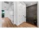 Hallway with dark brick accent wall, hardwood floors and white doors at 306 W Culver St, Phoenix, AZ 85003