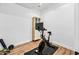Home gym featuring stationary bike, hardwood floors and neutral color scheme at 306 W Culver St, Phoenix, AZ 85003