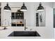 Bright kitchen with a deep sink and pendant lights illuminating the large island at 306 W Culver St, Phoenix, AZ 85003