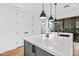 Kitchen with an island, pendant lights, gray cabinets, and stainless appliances at 306 W Culver St, Phoenix, AZ 85003