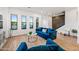 Stylish living area with blue velvet sofas, hardwood floors, and bright natural light at 306 W Culver St, Phoenix, AZ 85003