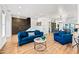 Bright living room with hardwood floors, stylish blue seating, and modern brick accent wall, creating an inviting atmosphere at 306 W Culver St, Phoenix, AZ 85003