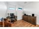 Bright office area boasts wood floors, built-in desk, modern fixtures, and two windows for natural light at 306 W Culver St, Phoenix, AZ 85003