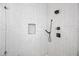 Close-up of a glass shower featuring white tiled walls and a built-in niche at 306 W Culver St, Phoenix, AZ 85003