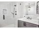 Modern shower with frameless glass doors, rain head, and white tiled walls at 306 W Culver St, Phoenix, AZ 85003