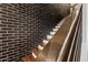 Interior staircase with wood steps, dark brick wall and metal handrail at 306 W Culver St, Phoenix, AZ 85003