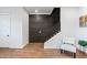 Modern staircase with dark brick accent wall and white accent chair at 306 W Culver St, Phoenix, AZ 85003