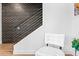 Close up view of a staircase featuring a dark brick accent wall and metal handrail at 306 W Culver St, Phoenix, AZ 85003