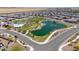 Aerial view of the community featuring a pool, park, playground, lake, and green space at 35175 W Marin Ave, Maricopa, AZ 85138
