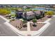 Aerial view of the community clubhouse, pool, splash pad, playground, pond, and landscaping at 35175 W Marin Ave, Maricopa, AZ 85138
