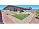 A patio with artificial grass complemented by paved walkways and a well-maintained outdoor space at 35175 W Marin Ave, Maricopa, AZ 85138